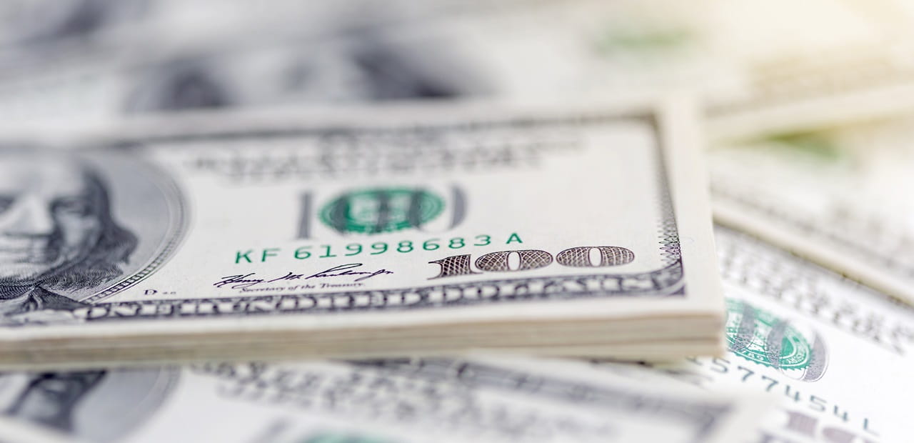 Close-up view of a stack of 100 dollar bills.